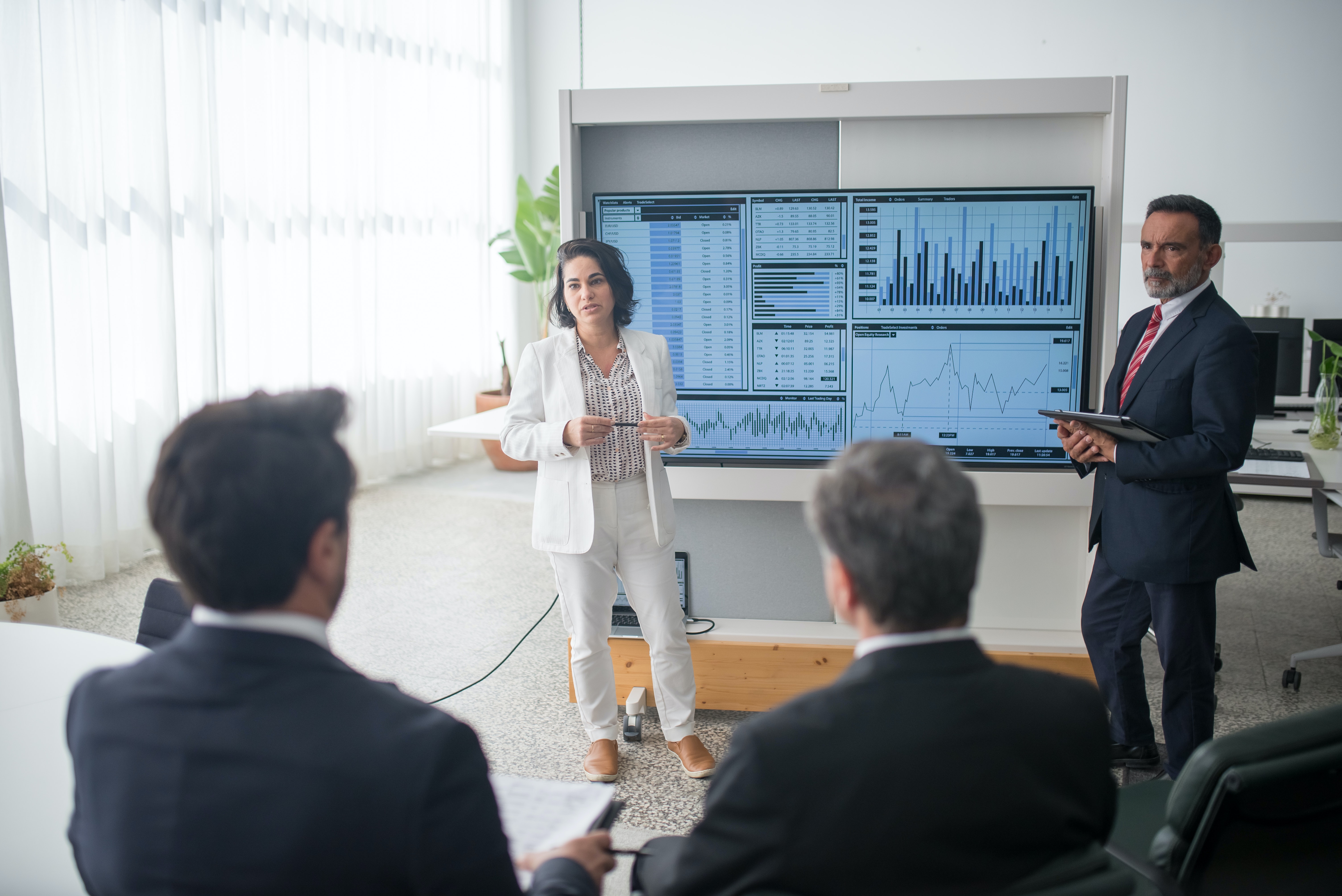 developers looking at a screen and discussing software benefits