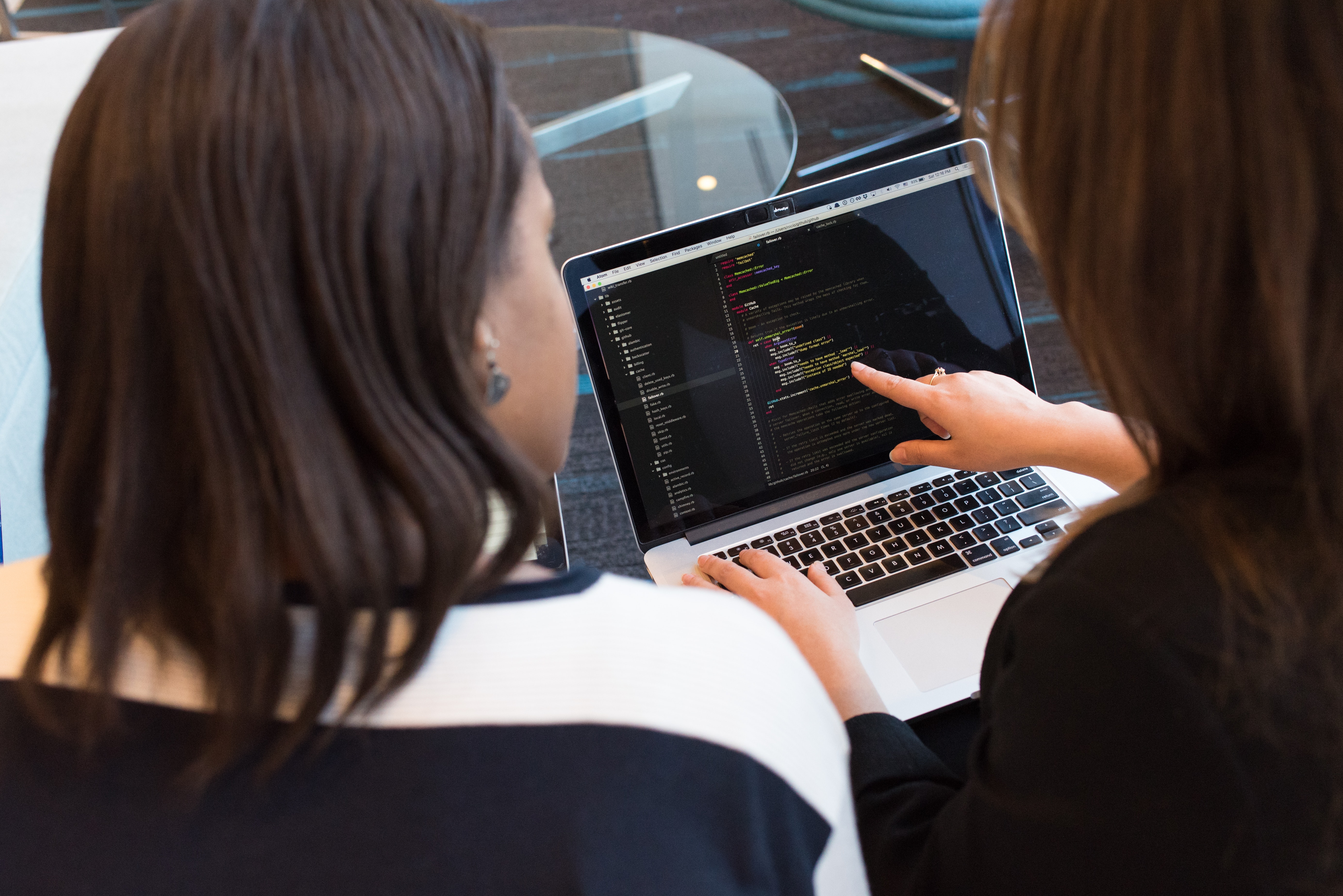 developers looking at a screen and discussing software benefits
