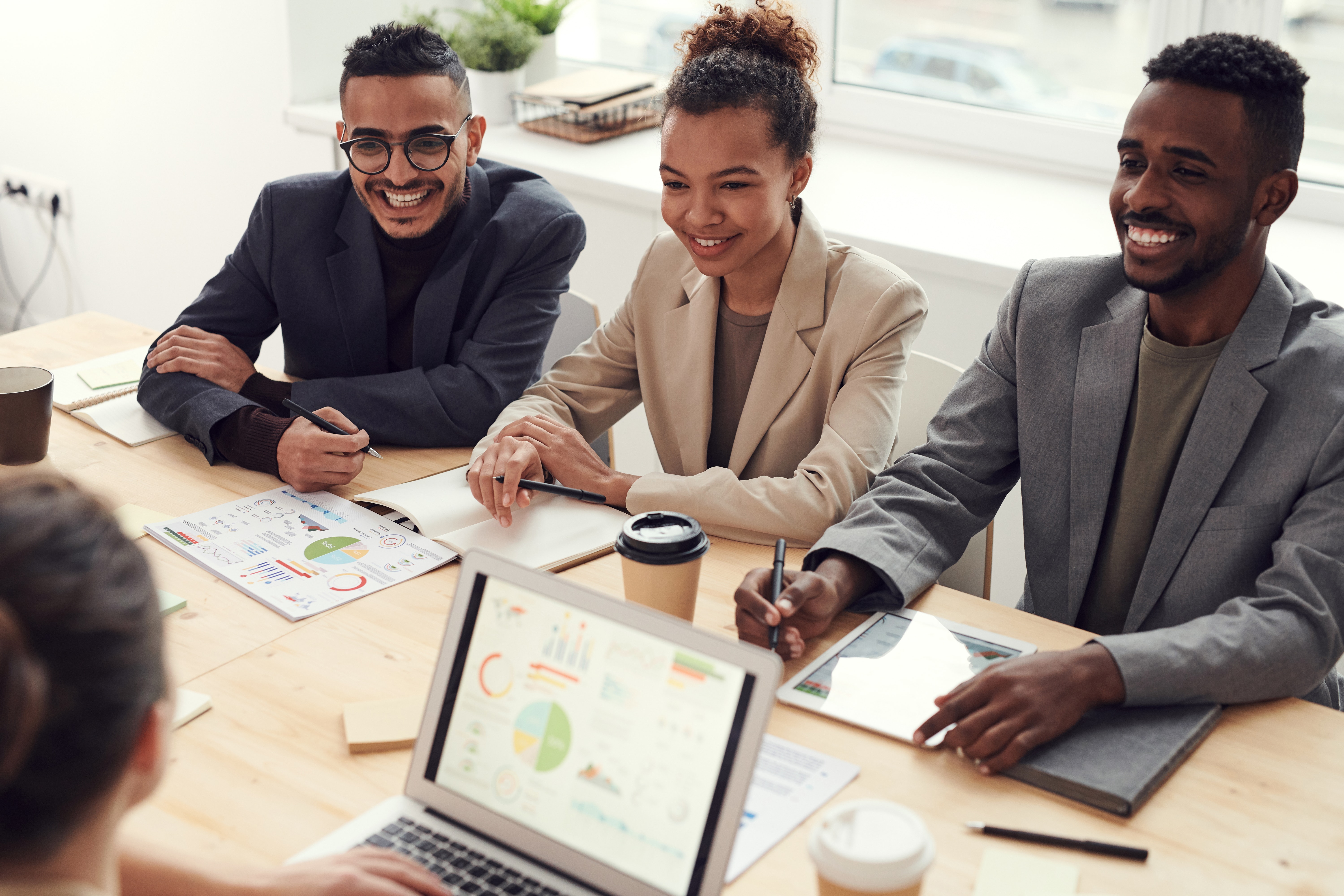 developers looking at a screen and discussing software benefits